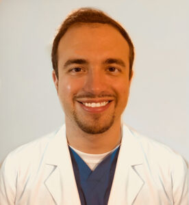 Smiling male doctor in a white coat.