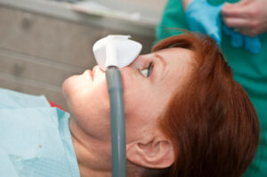 Patient receiving dental treatment with nasal mask.